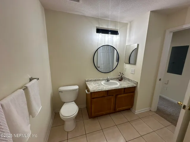 a bathroom with a toilet a sink and a mirror