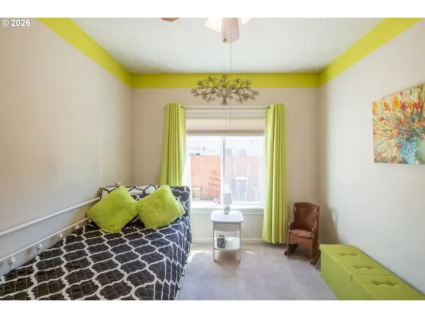 a bedroom with a bed and a chair
