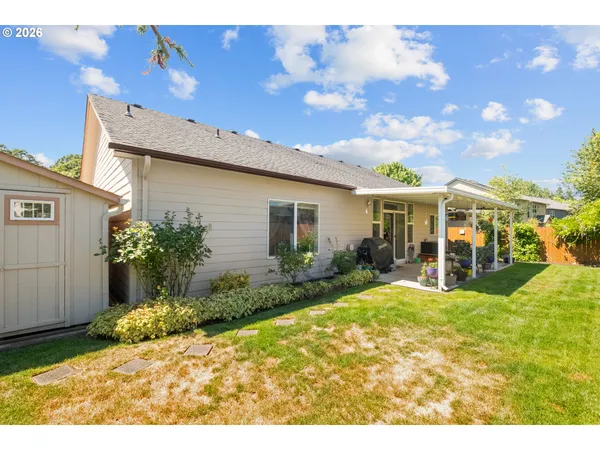 a view of a house with a wooden fence