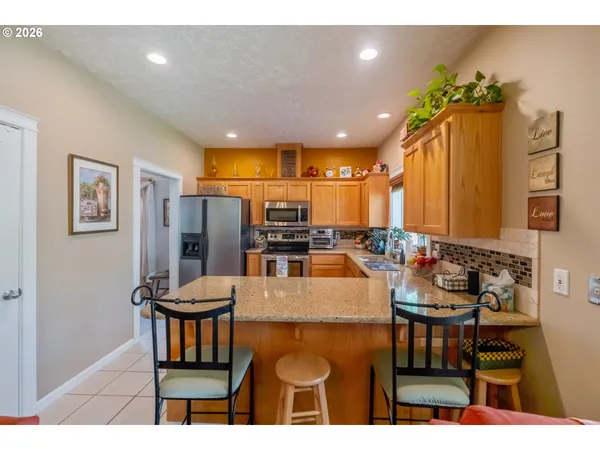 a kitchen with sink and refrigerator