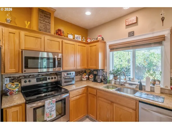 a kitchen with stainless steel appliances a stove sink and cabinets