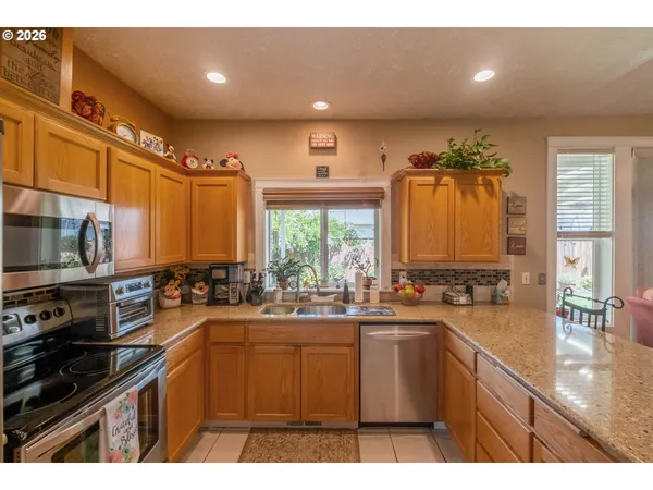 a kitchen with lots of counter top space a sink and appliances