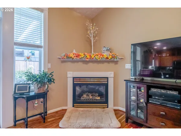a living room with furniture a potted plant and a fireplace