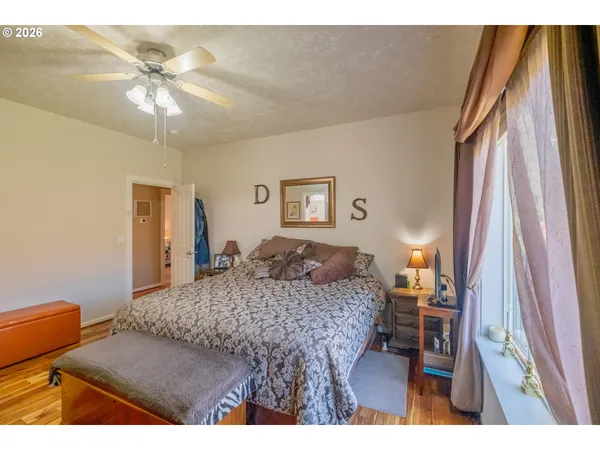 a bedroom with a bed and a flat tv screen on dresser