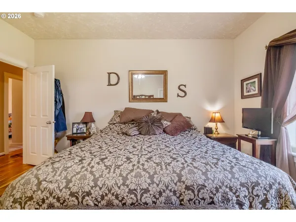 a living room with a bed and a large window