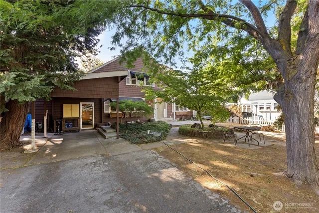 a view of a two chairs in a backyard