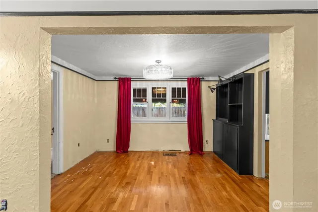 a view of hallway with wooden floor and chandelier