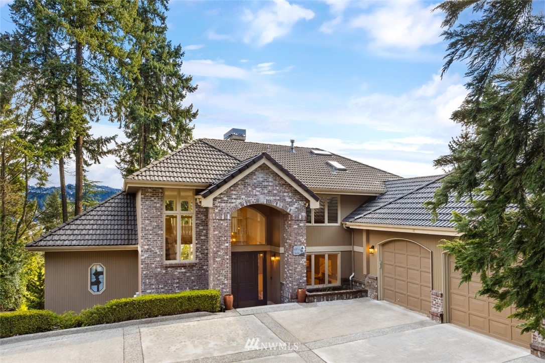 5648 East Mercer Way Mercer Island, WA 98040 - Photo 2 of 26 a front view of a house with a yard and garage