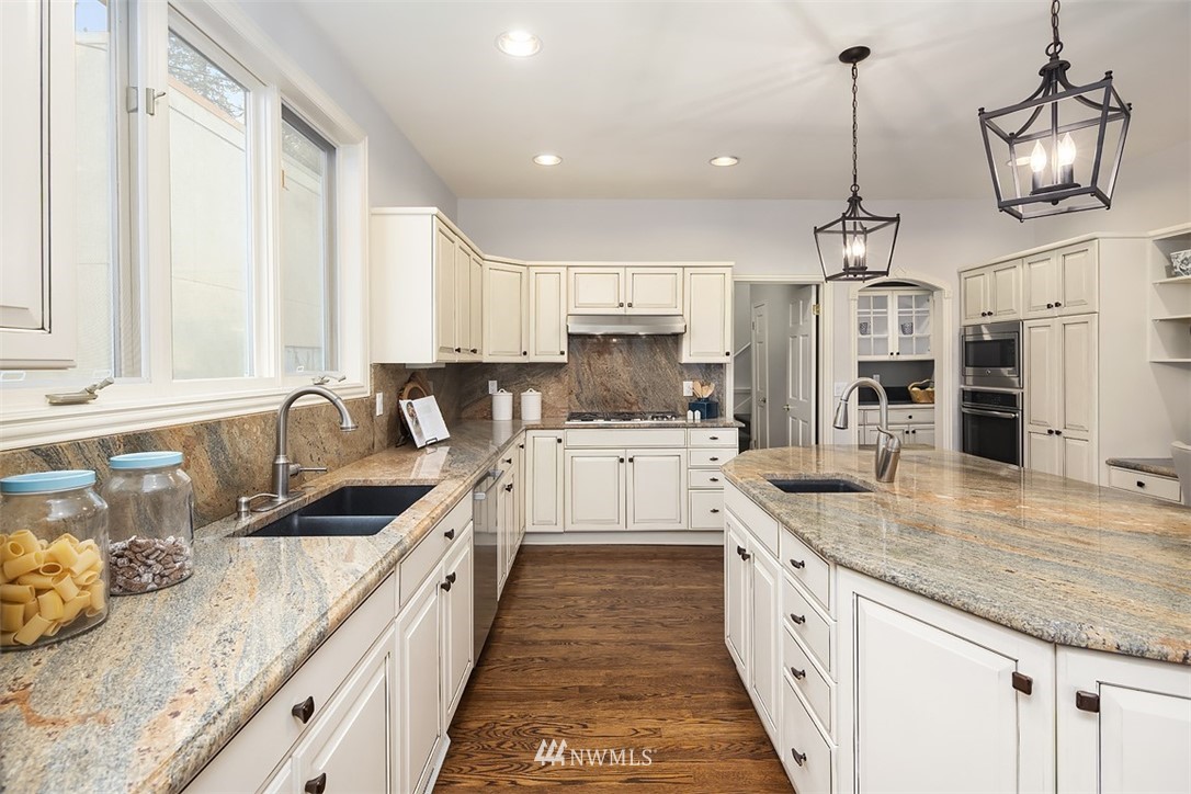 5648 East Mercer Way Mercer Island, WA 98040 - Photo 12 of 26 a large kitchen with granite countertop a sink a counter top space appliances and cabinets