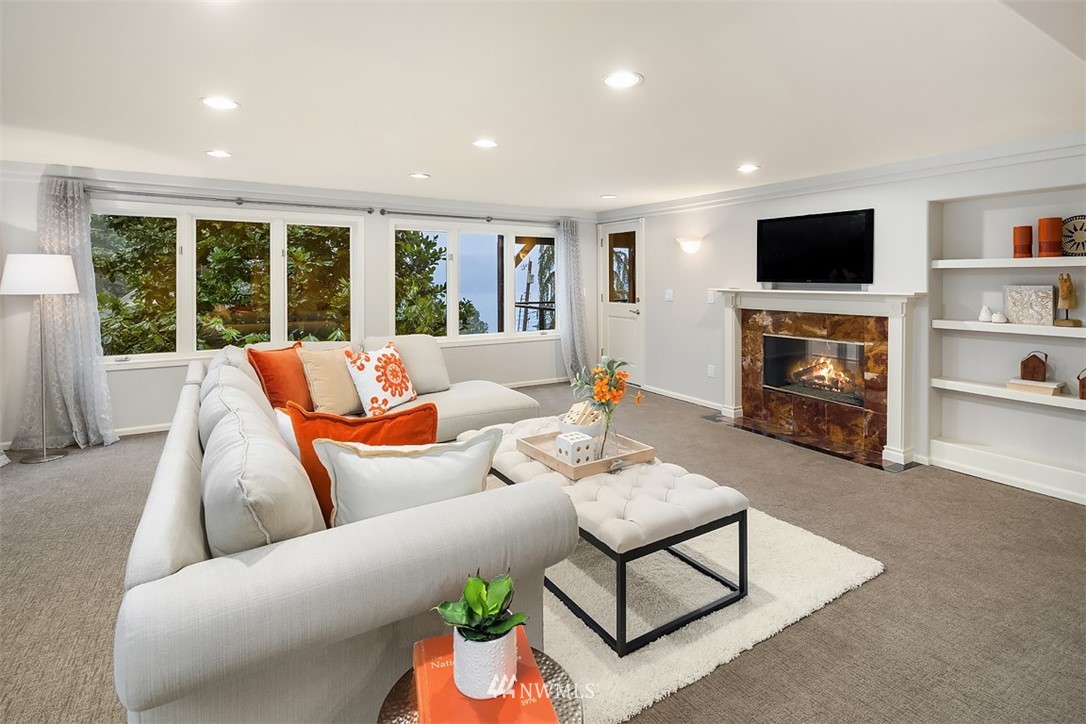 5648 East Mercer Way Mercer Island, WA 98040 - Photo 22 of 26 a living room with furniture a flat screen tv and a fireplace