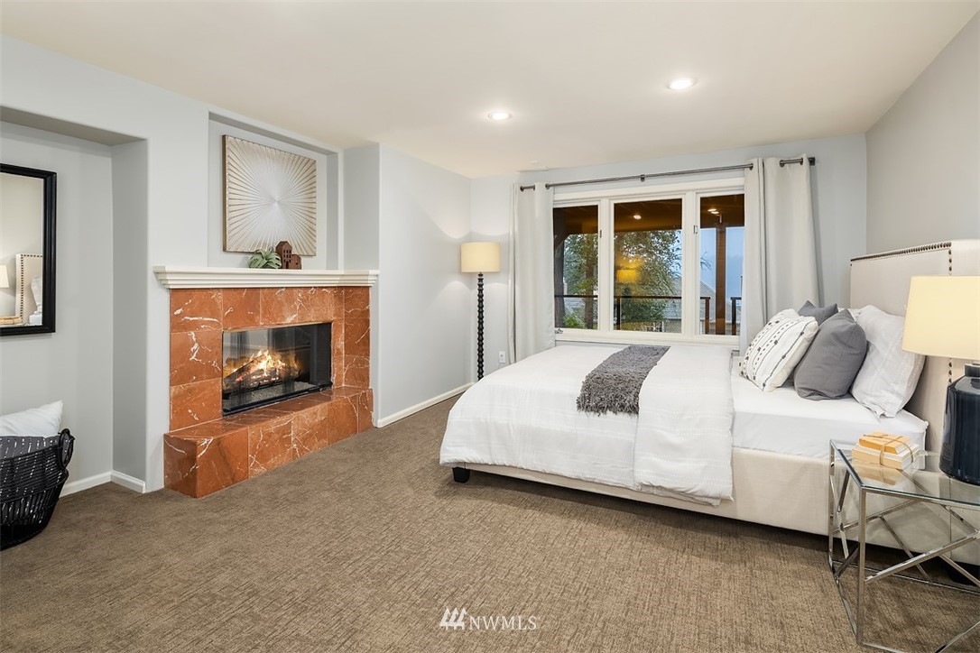5648 East Mercer Way Mercer Island, WA 98040 - Photo 23 of 26 a bedroom with a bed and a fireplace
