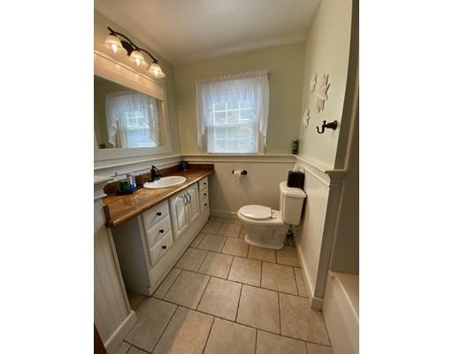 103 Chicago Street Fall River, MA 02721 - Photo 17 of 39 a spacious bathroom with a granite countertop sink a toilet and a mirror