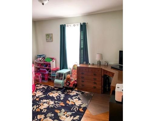 103 Chicago Street Fall River, MA 02721 - Photo 18 of 39 a room with a baby crib and a couch