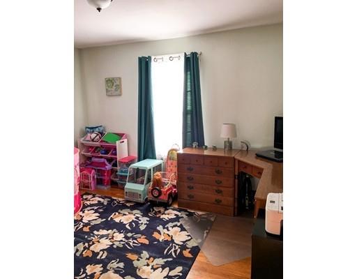 103 Chicago Street Fall River, MA 02721 - Photo 19 of 39 a room with a baby crib and a couch