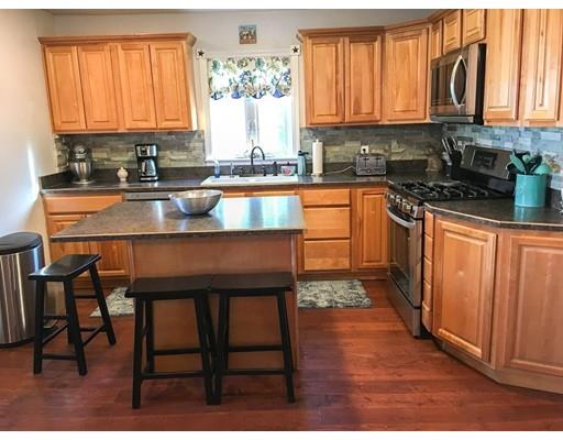103 Chicago Street Fall River, MA 02721 - Photo 5 of 39 a kitchen with stainless steel appliances granite countertop a stove top oven a sink dishwasher and cabinets with wooden floor