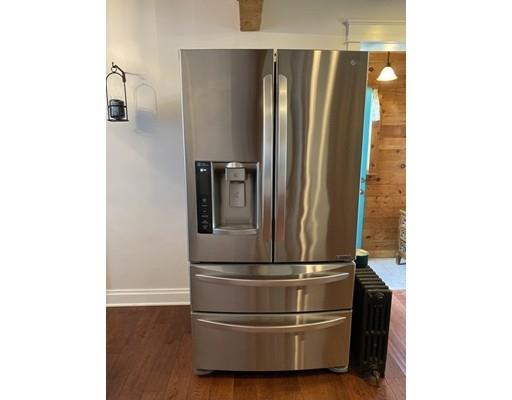 103 Chicago Street Fall River, MA 02721 - Photo 6 of 39 a metallic refrigerator freezer sitting in a kitchen