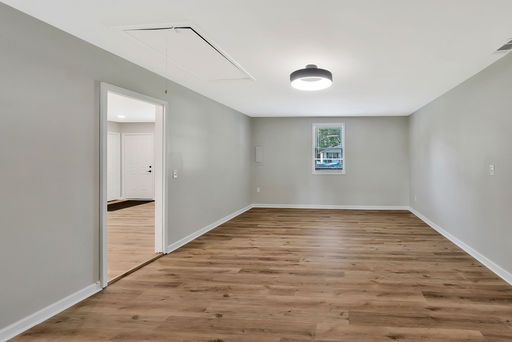213 Manzano Road Madison, TN 37115 - Photo 9 of 24 a view of an empty room with wooden floor and a window