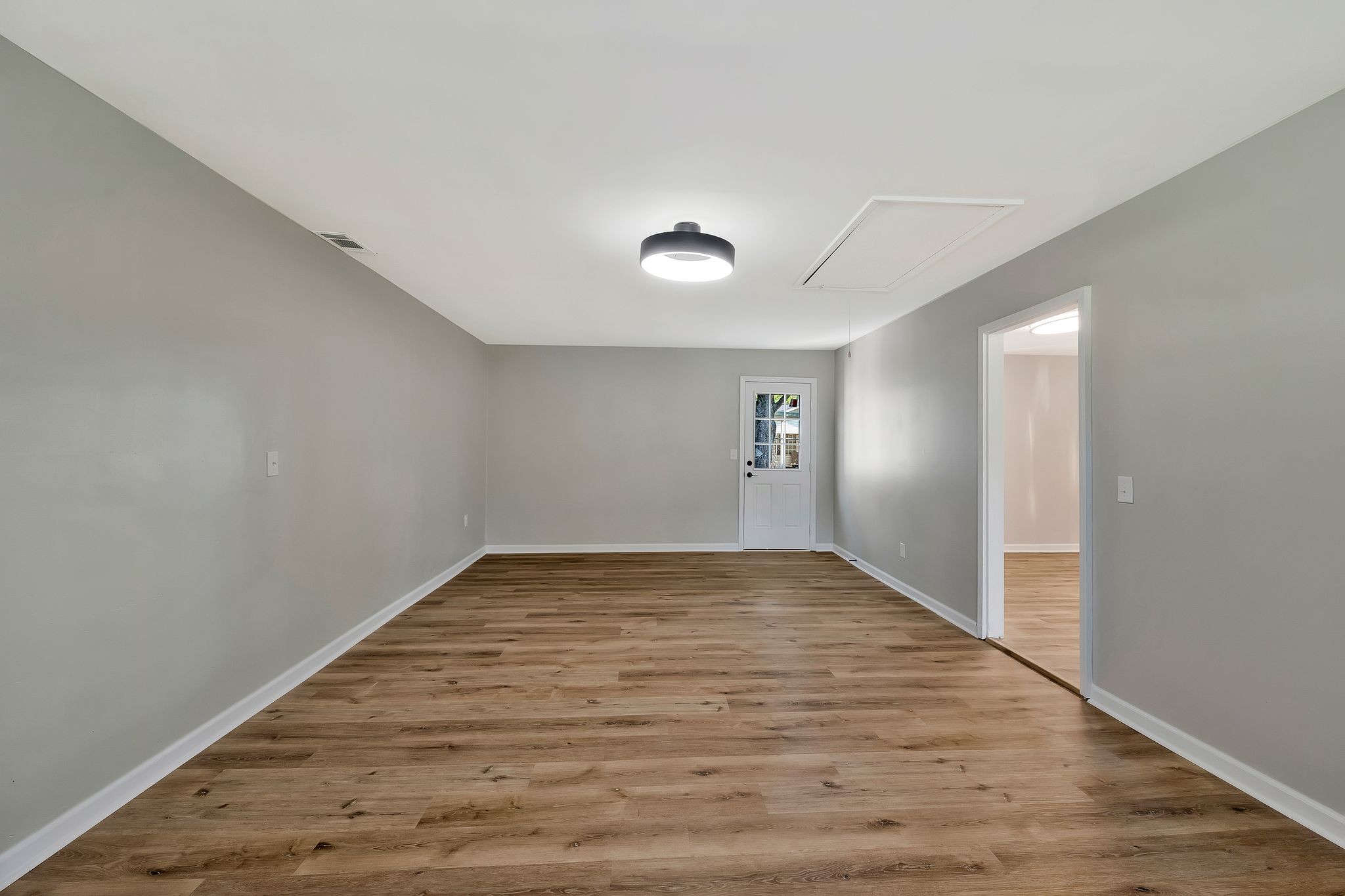 213 Manzano Road Madison, TN 37115 - Photo 10 of 24 a view of an empty room with wooden floor and a window
