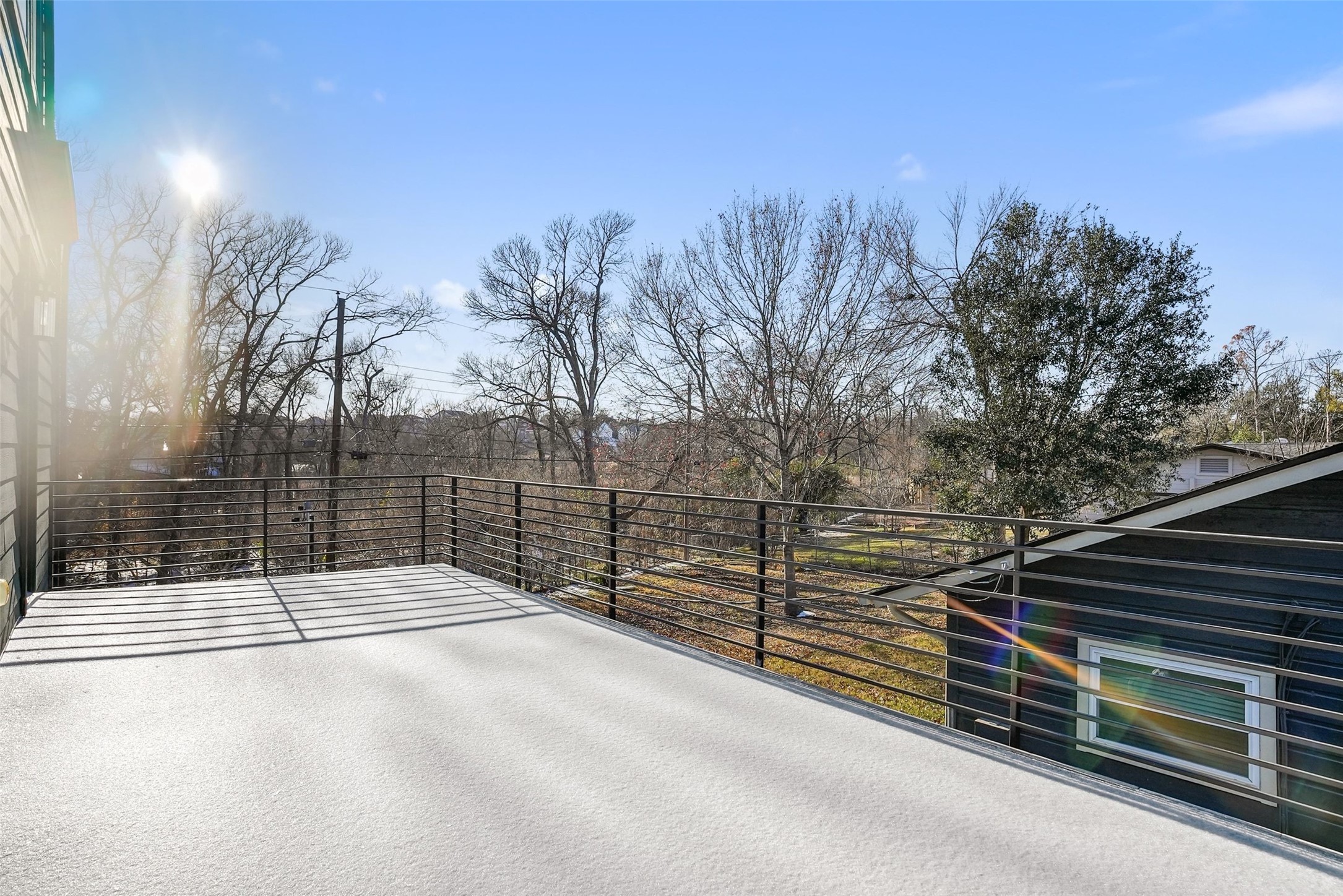 5109 Stone Gate Drive, Unit 2 Austin, TX 78721 - Photo 29 of 36 Expansive rooftop deck featuring a light-colored surface and a sleek metal railing