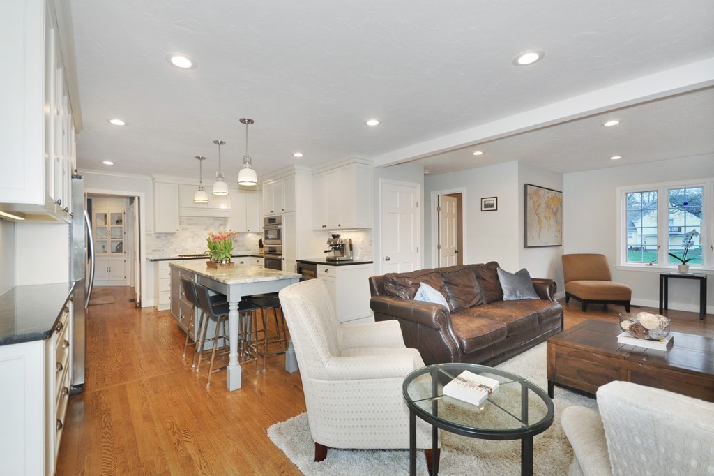 23 Wright Farm, Unit 23 Concord, MA 01742 - Photo 11 of 30 a living room kitchen with a dining table wooden floor and a view of kitchen