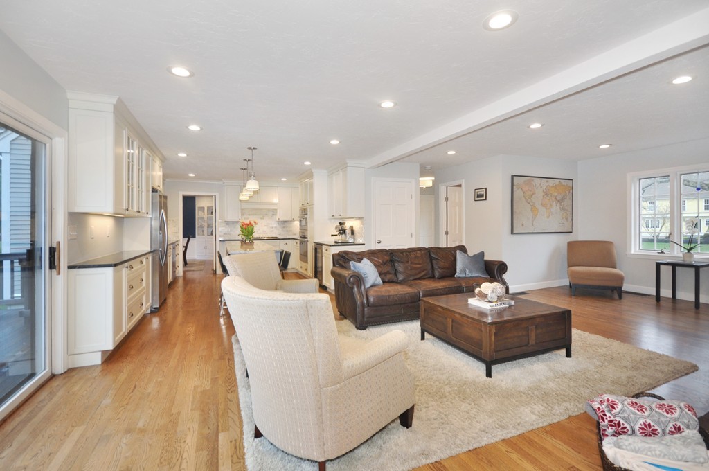23 Wright Farm, Unit 23 Concord, MA 01742 - Photo 12 of 30 a living room with furniture kitchen view and a wooden floor