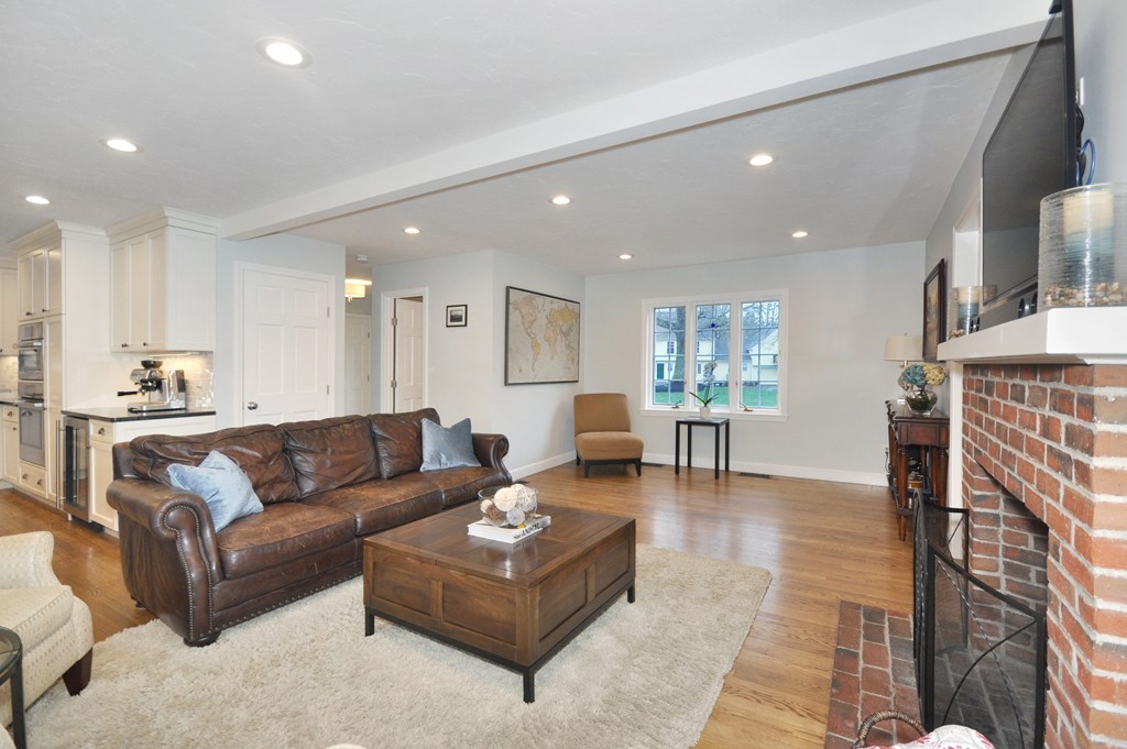 23 Wright Farm, Unit 23 Concord, MA 01742 - Photo 13 of 30 a living room with fireplace furniture and a dining table with kitchen view