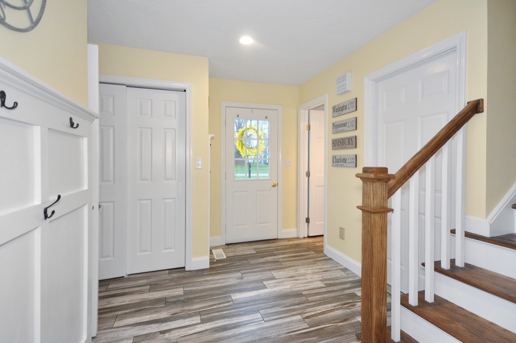 23 Wright Farm, Unit 23 Concord, MA 01742 - Photo 16 of 30 a view of a hallway with wooden floor and staircase