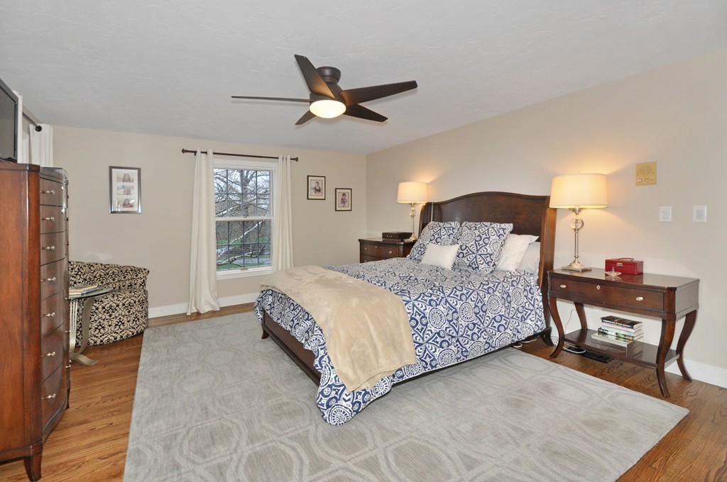 23 Wright Farm, Unit 23 Concord, MA 01742 - Photo 20 of 30 a bedroom with a bed and a dresser with rug
