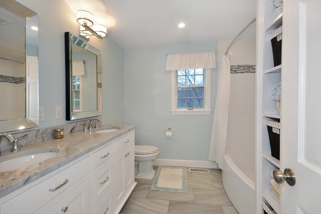 23 Wright Farm, Unit 23 Concord, MA 01742 - Photo 24 of 30 a bathroom with a granite countertop sink toilet and shower