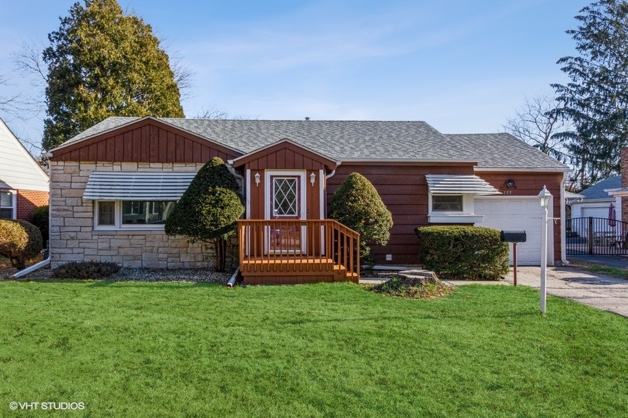 195 Ridge Avenue Crystal Lake, IL 60014 - Photo 1 of 15 a front view of a house with a yard