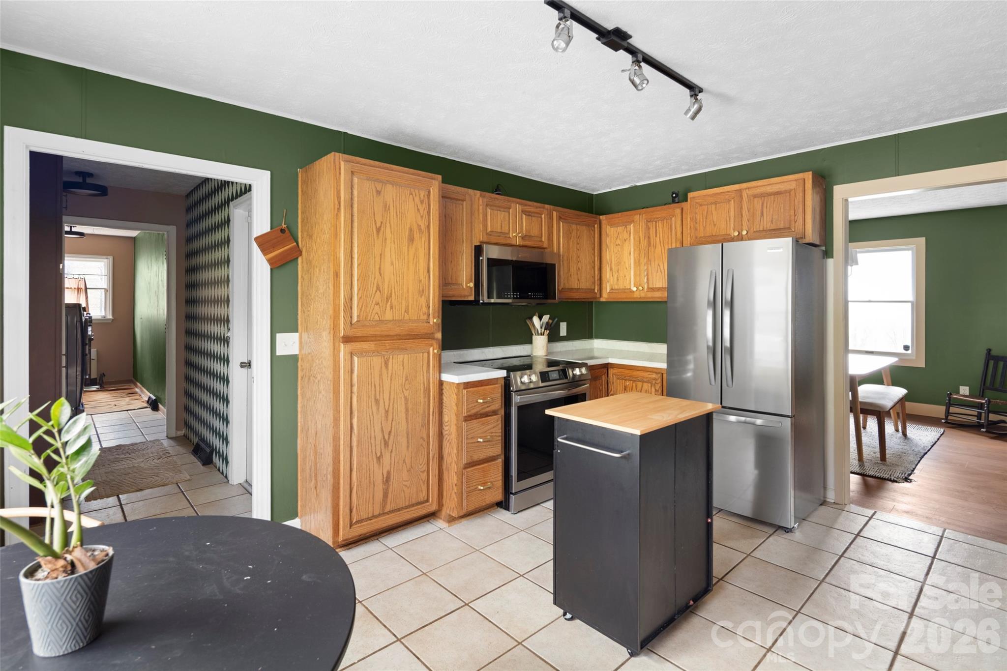 17 Boyd Cove Road Leicester, NC 28748 - Photo 12 of 40 a kitchen with stainless steel appliances granite countertop a refrigerator a stove top oven a sink dishwasher and a refrigerator with wooden floor