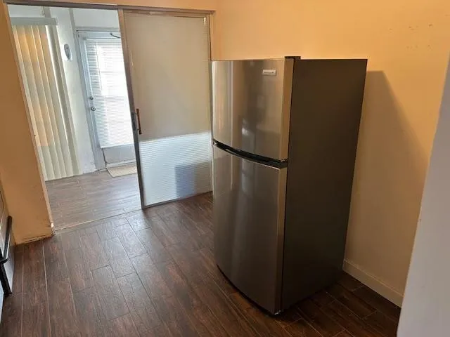 an empty room with wooden floor and a window