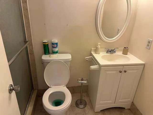 a bathroom with a toilet a sink and a mirror