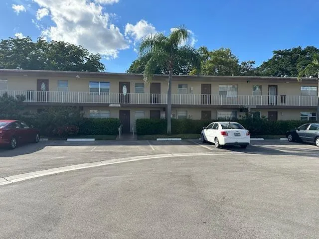a car parked in front of a white house