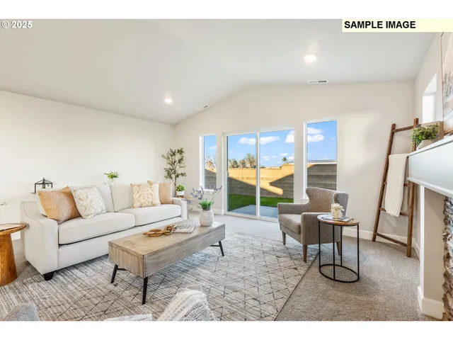 a living room with furniture and a floor to ceiling window