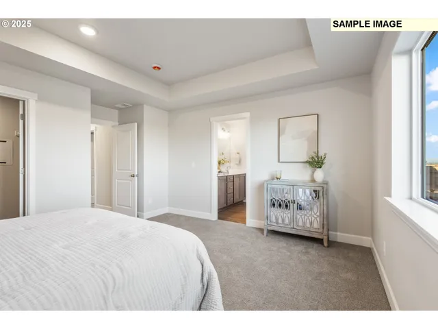 a en suite bathroom with a double vanity sink and a mirror
