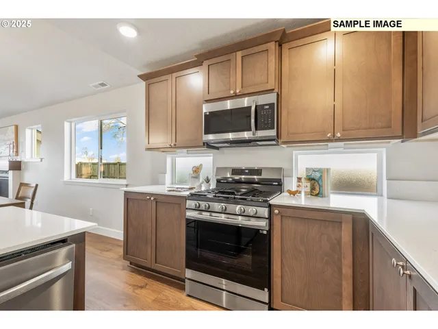 a kitchen with a stove a sink and a microwave