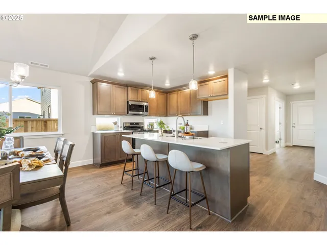 a open kitchen with stainless steel appliances kitchen island granite countertop a sink and cabinets