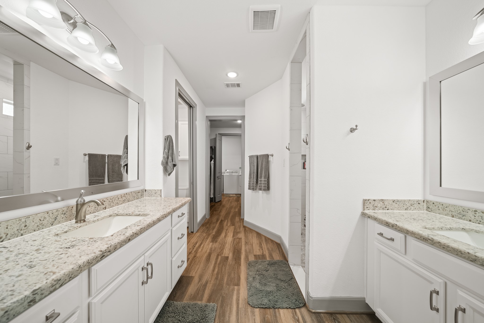 5739 Bobwhite Trail Manvel, TX 77578 - Photo 18 of 29 A spacious ensuite offers dual sinks, abundant cabinetry, and a seamless connection to the walk-in closet and laundry room. Every detail has been thoughtfully planned for convenience.