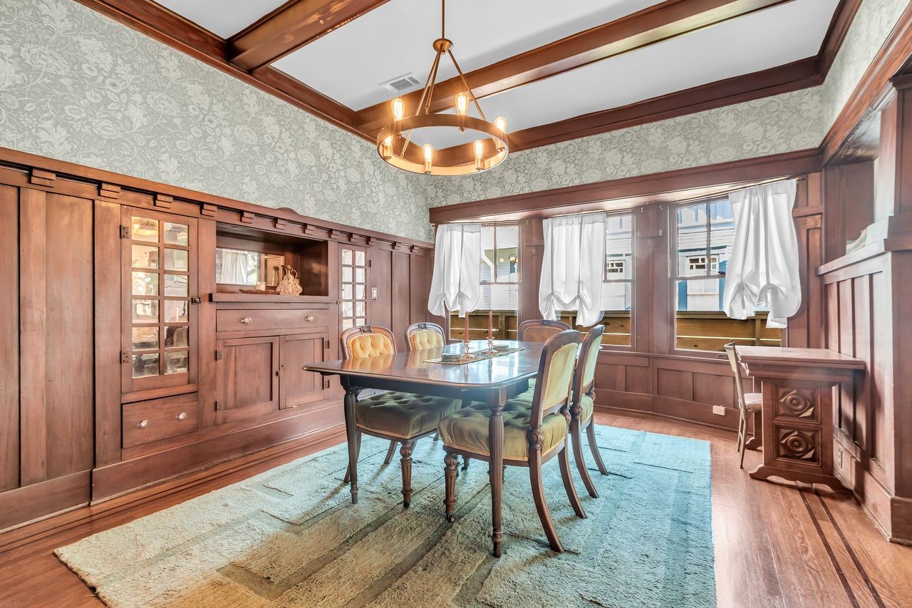 2608 Hopkins Street Houston, TX 77006 - Photo 11 of 42 a dining room with wooden floor a chandelier a wooden table and chairs