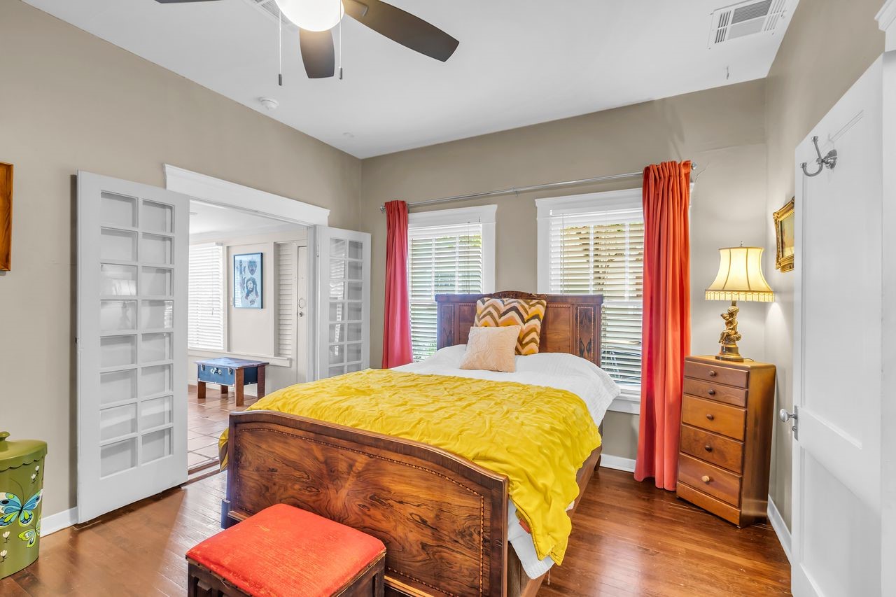 2608 Hopkins Street Houston, TX 77006 - Photo 19 of 42 a bedroom with a bed and wooden floor