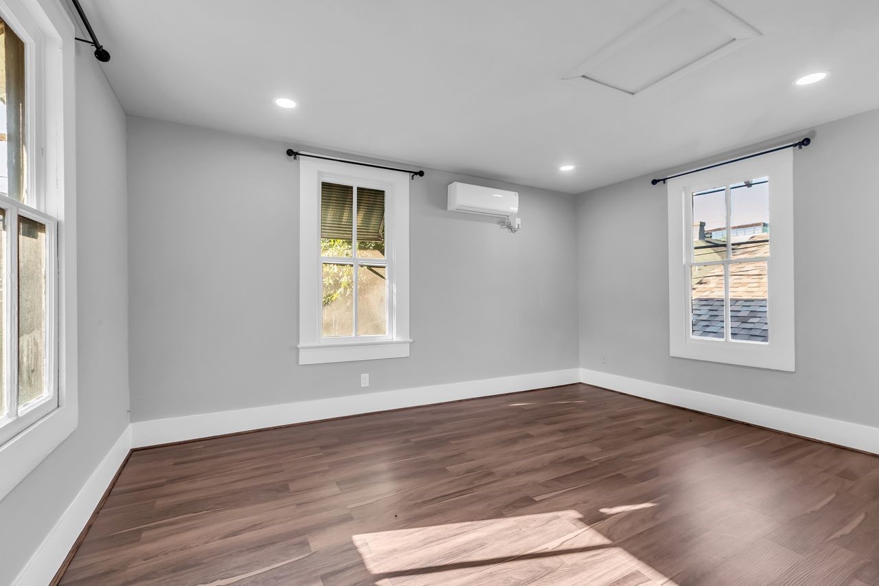 2608 Hopkins Street Houston, TX 77006 - Photo 32 of 42 an empty room with wooden floor and windows