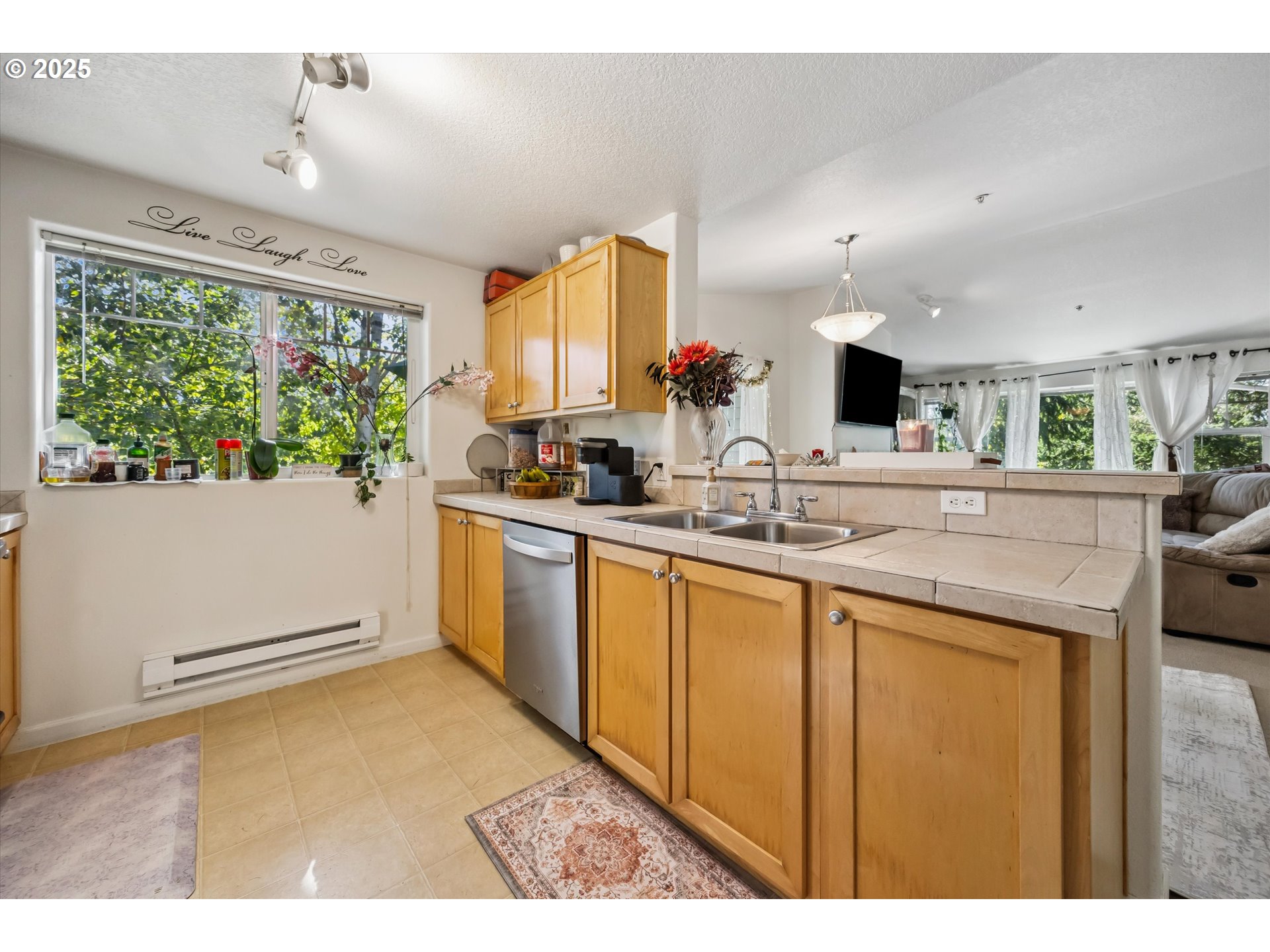 730 Northwest 185th Avenue, Unit 307 Beaverton, OR 97006 - Photo 14 of 46 a kitchen with sink cabinets and outdoor view