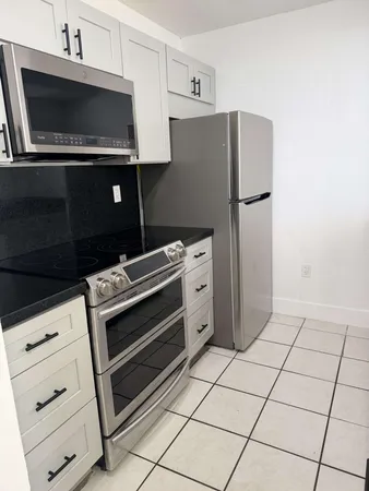 a kitchen with appliances and cabinets