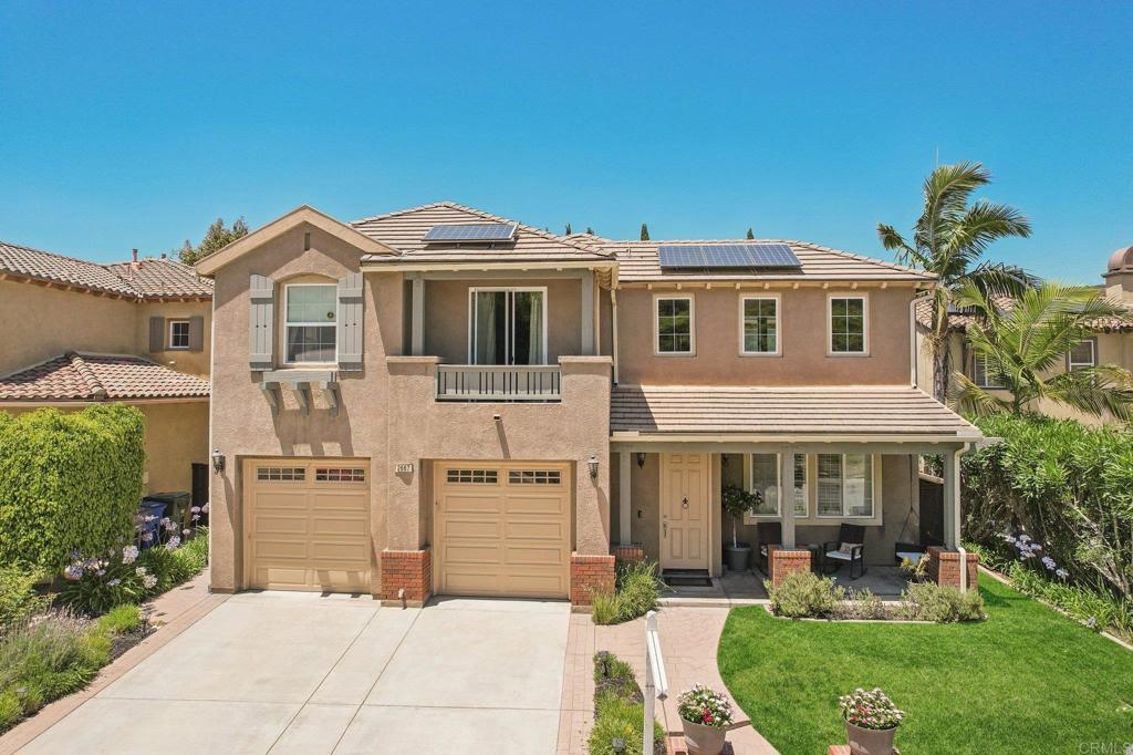 a front view of a house with garden and porch