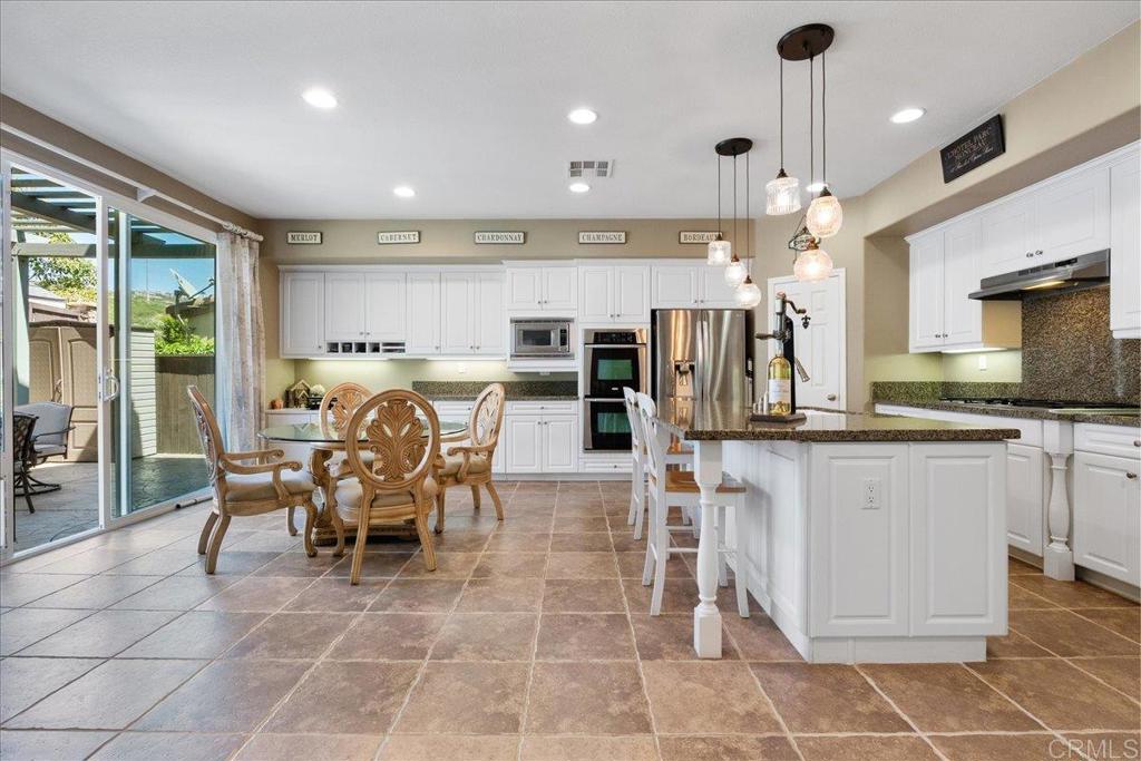 2667 Fallsview Road San Marcos, CA 92078 - Photo 22 of 54 a large kitchen with a table and chairs