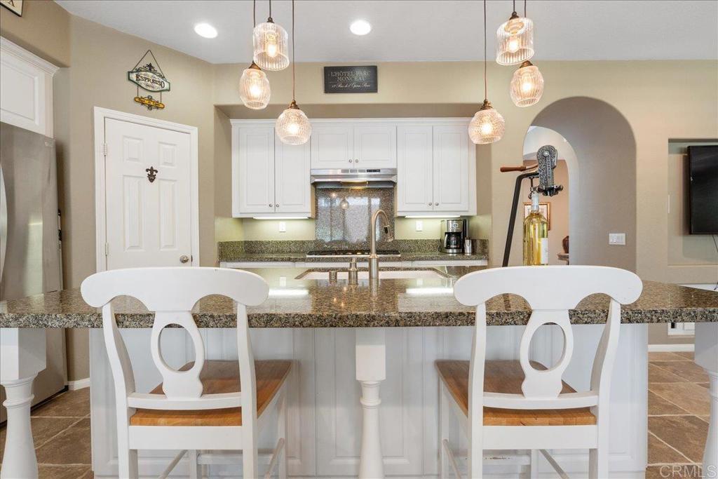 2667 Fallsview Road San Marcos, CA 92078 - Photo 25 of 54 a bathroom with a granite countertop sink a mirror and shower