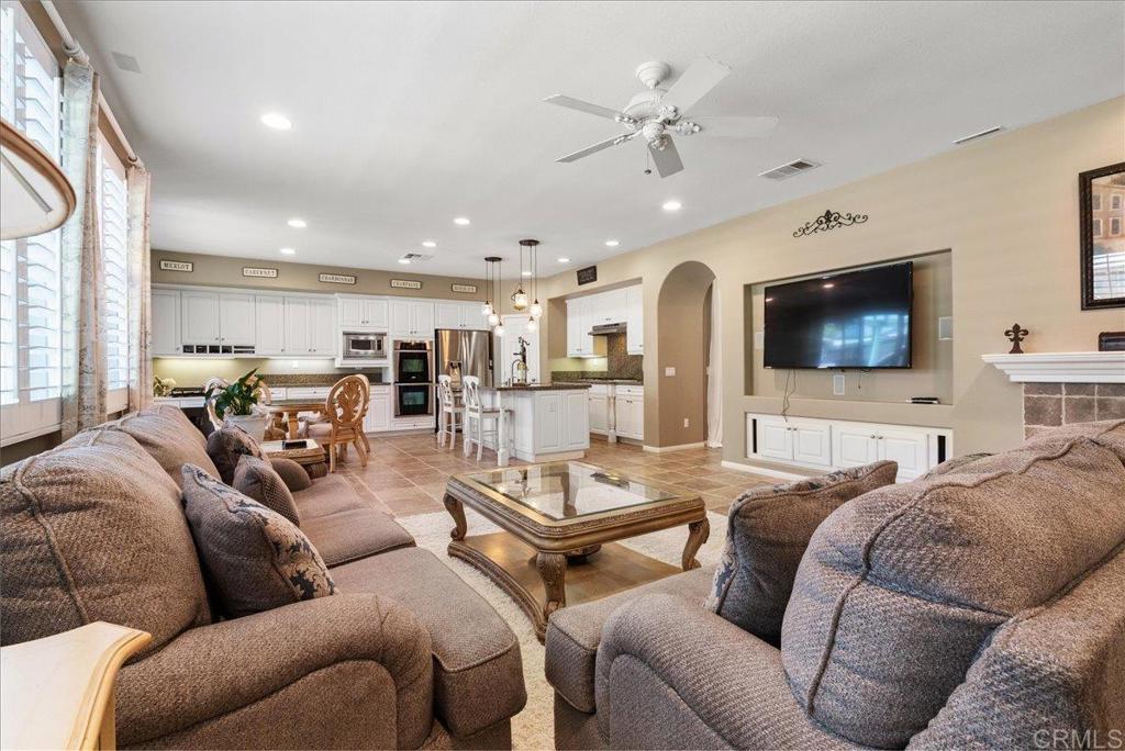 2667 Fallsview Road San Marcos, CA 92078 - Photo 27 of 54 a living room with furniture kitchen view and a flat screen tv