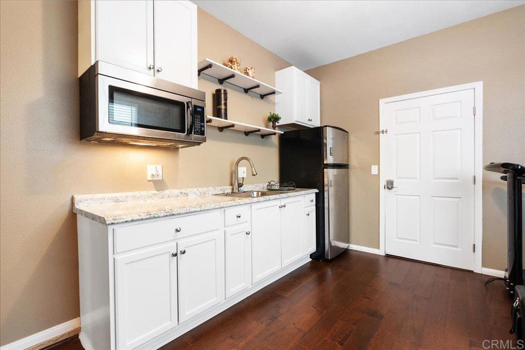 2667 Fallsview Road San Marcos, CA 92078 - Photo 32 of 54 a kitchen with stainless steel appliances granite countertop a stove microwave and refrigerator