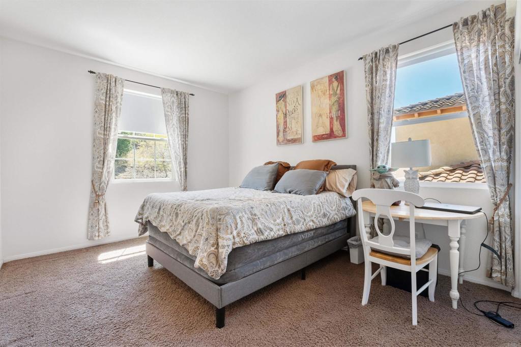 2667 Fallsview Road San Marcos, CA 92078 - Photo 38 of 54 a bedroom with a bed and a table in it